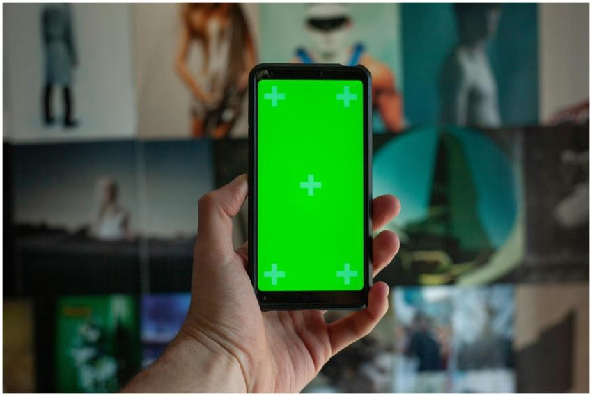 A close-up of a person's hand holding a smartphone