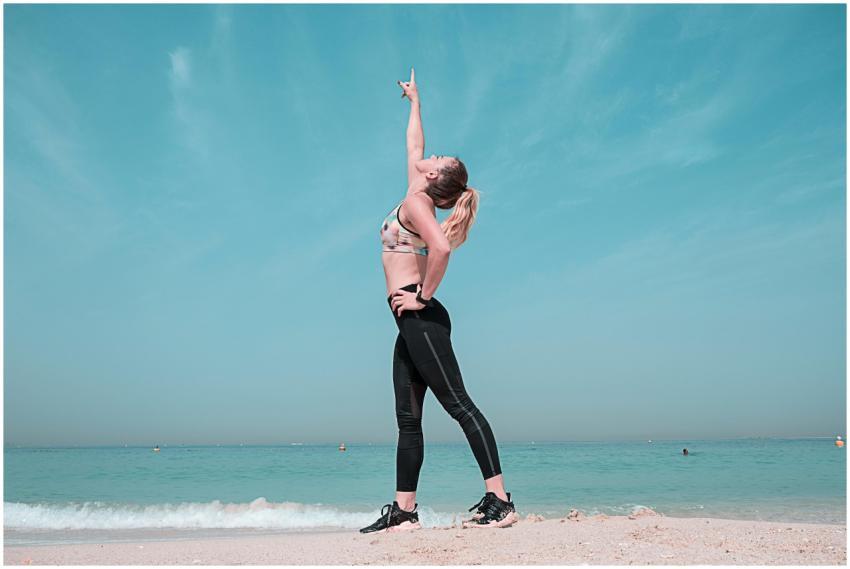 A woman performing a stretching exercise on a sunn