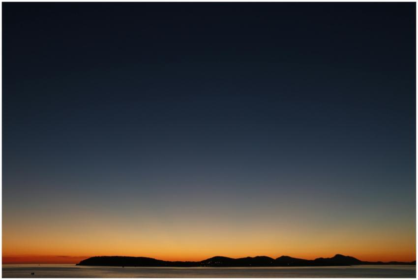 Beautiful sunset over an island silhouette with a