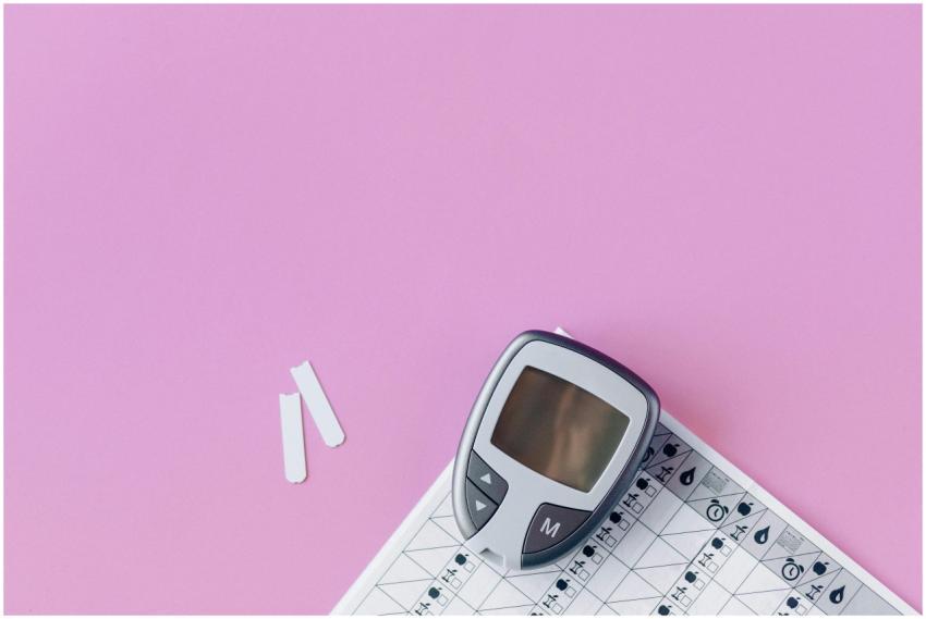 Flat lay of a blood glucose monitor and test strip