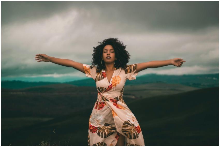 A woman in a flowing dress enjoys peaceful moments