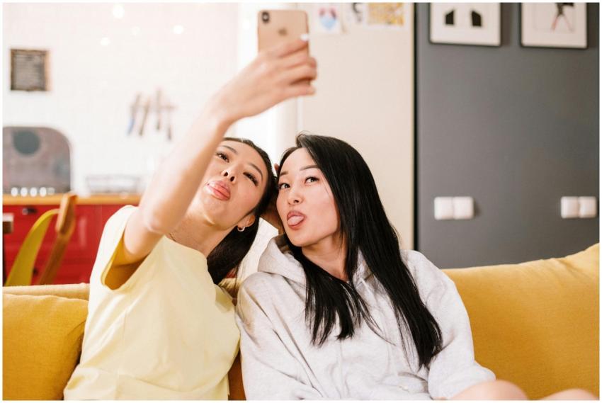Two friends make funny faces while taking a selfie