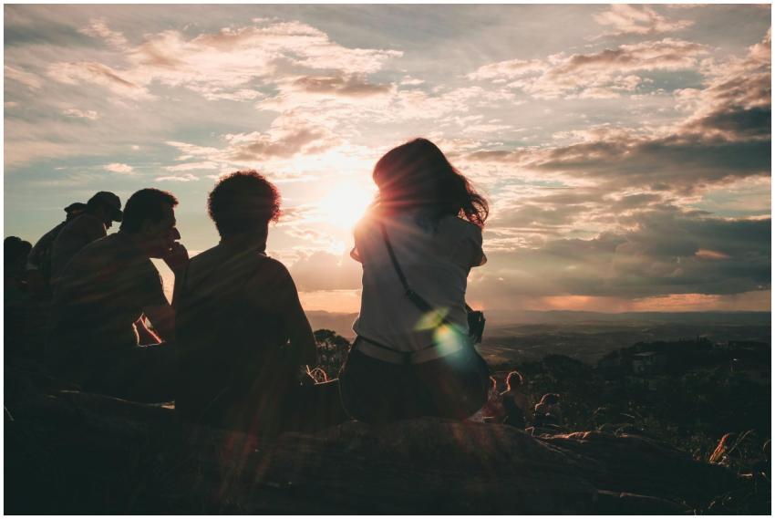 A group of people enjoy a breathtaking sunset view