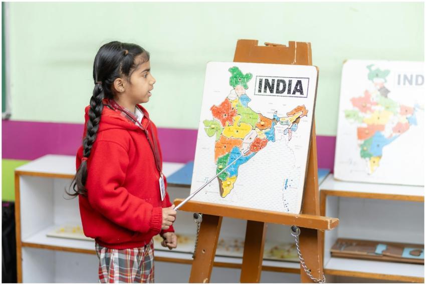 Young student points to India map in a classroom,