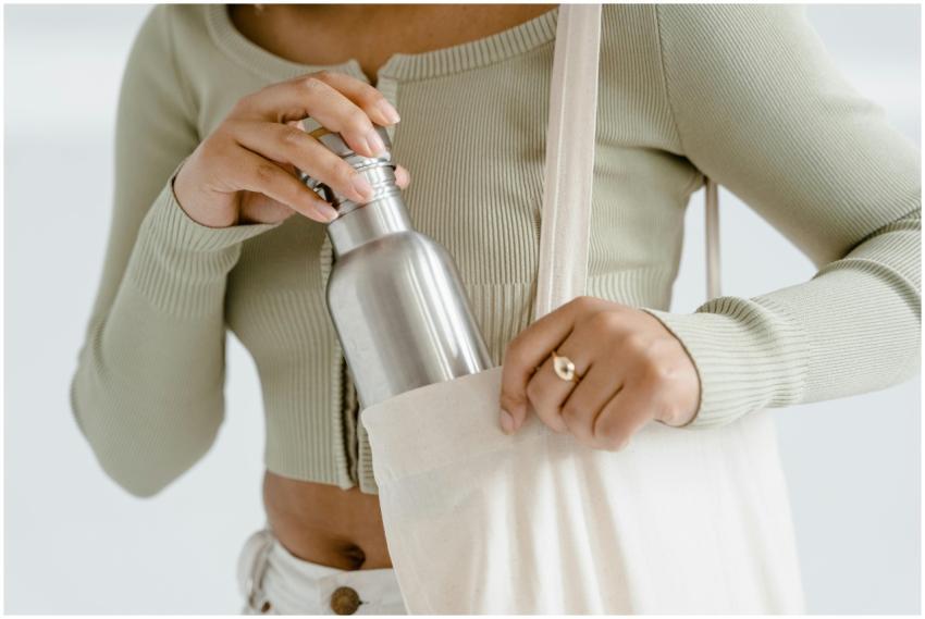 Close-up of woman placing a stainless steel water
