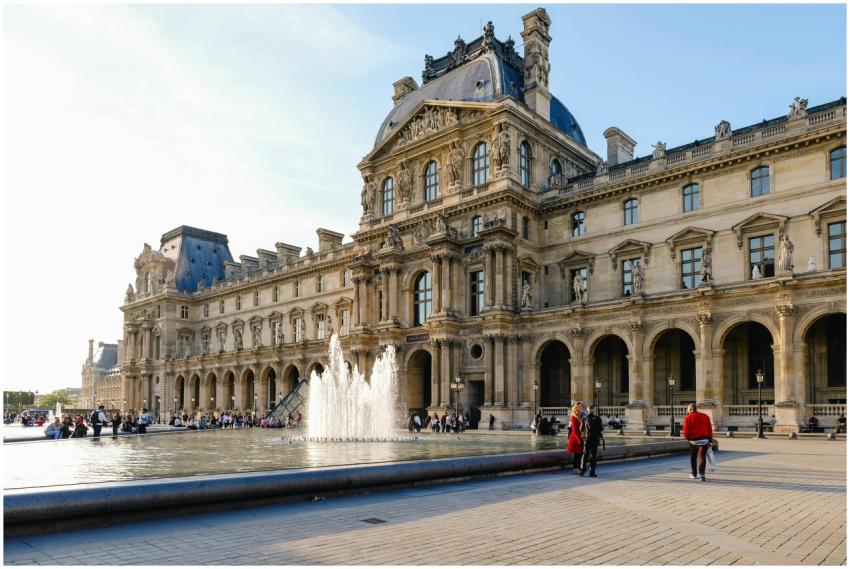View of the Louvre Museum with a fountain in the c