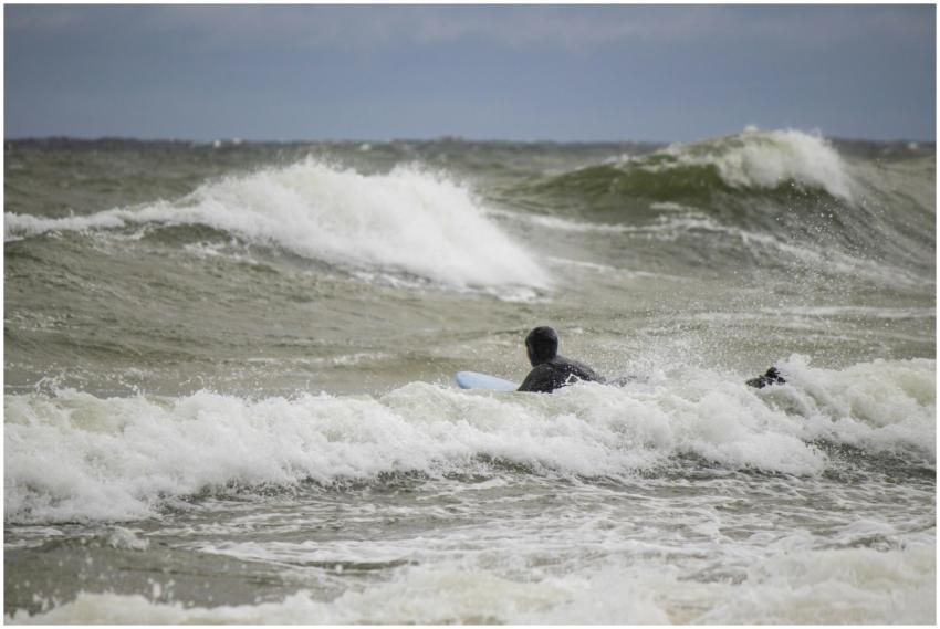 Surfer riding challenging waves in Jastrzębia Góra