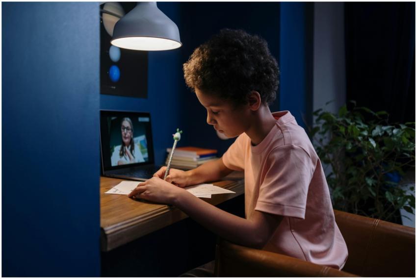 A child focused on online learning with a laptop a