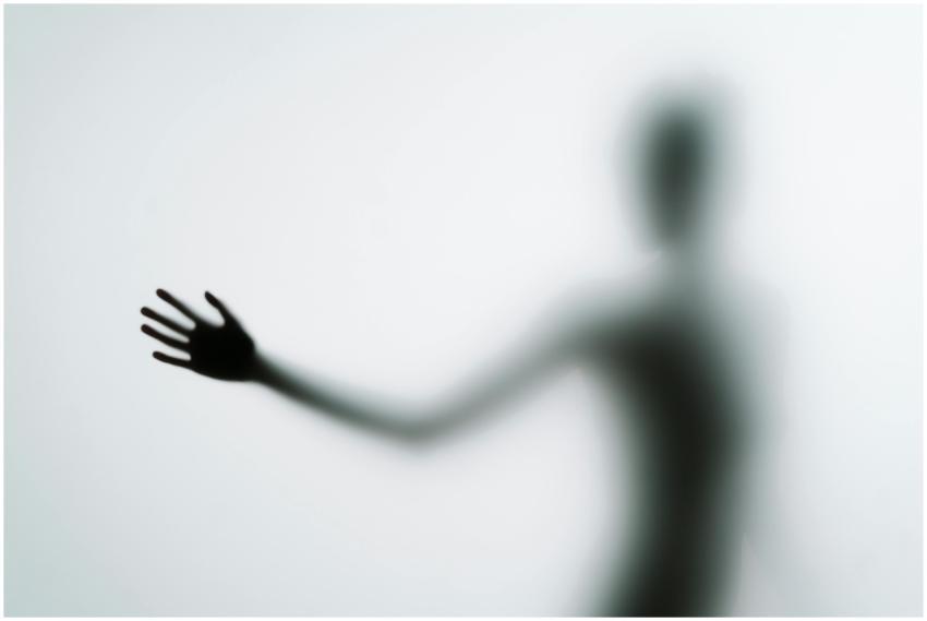 Blurred silhouette of a hand reaching out against