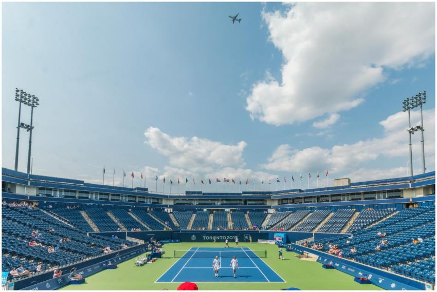 Dynamic tennis match in progress at an outdoor sta