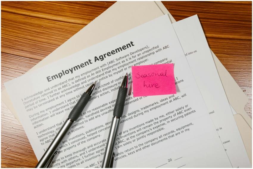 Top view of employment agreement contract with pen