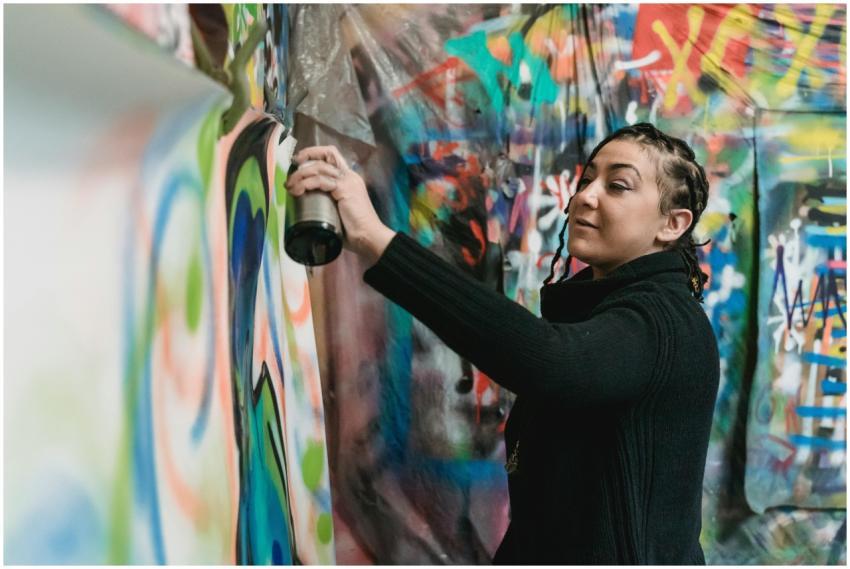 Talented street artist using spray paint to create