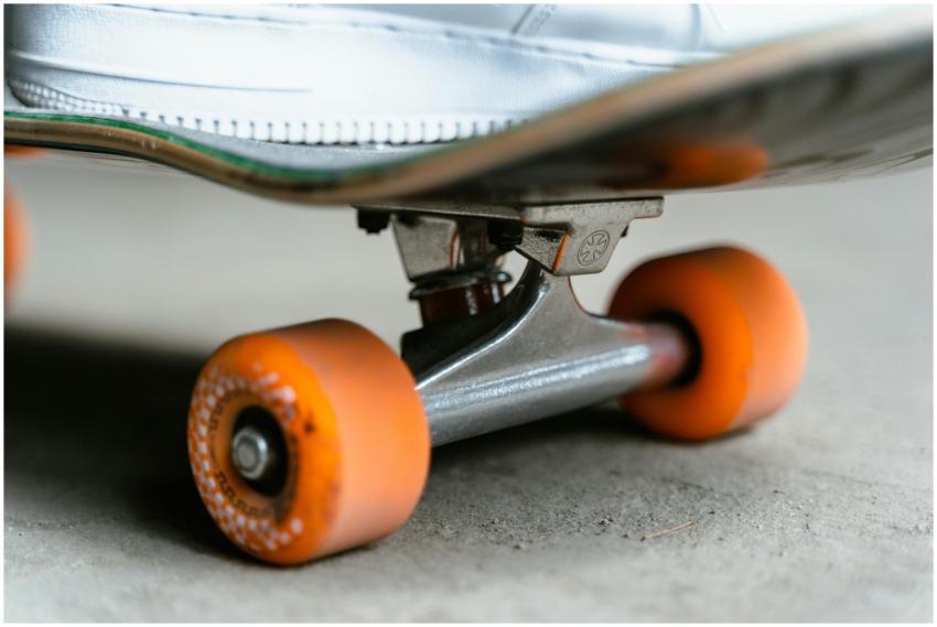 Detailed view of a skateboard with orange wheels o