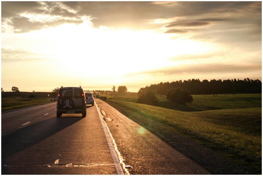 Tranquil highway with cars at sunset near Minas, U