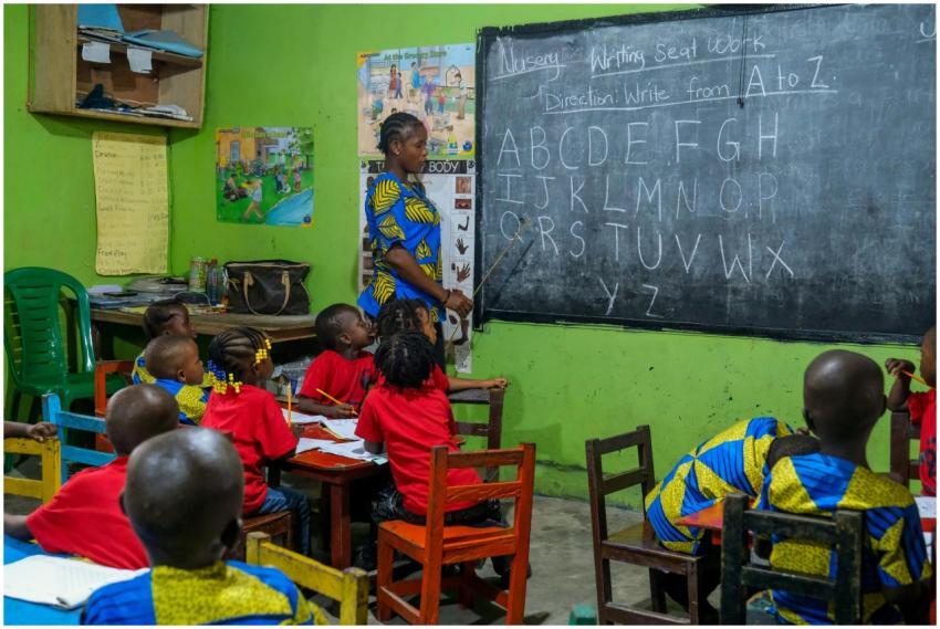 Young students learn the alphabet with a teacher i