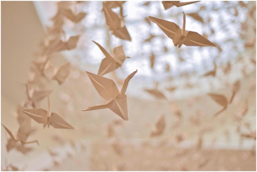 Dreamy paper origami cranes hanging beautifully in