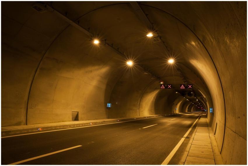 A long exposure photograph of a dimly lit urban tu