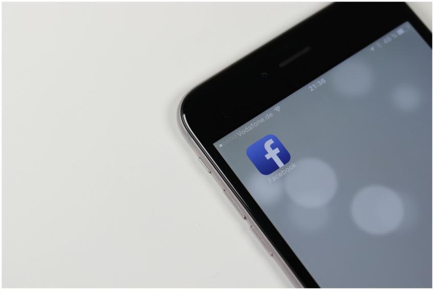 iPhone displaying Facebook app icon with blurred b