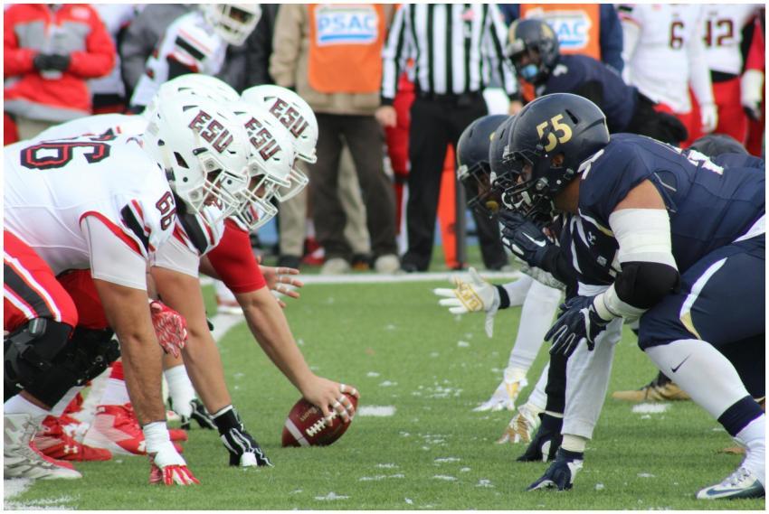 Rival football teams face off at the start of an a
