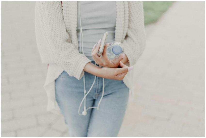 Casual young woman outdoors with water bottle and