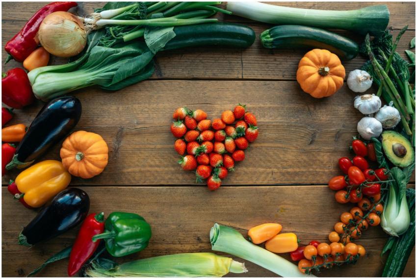 Vibrant fruits and vegetables arranged heart-shape