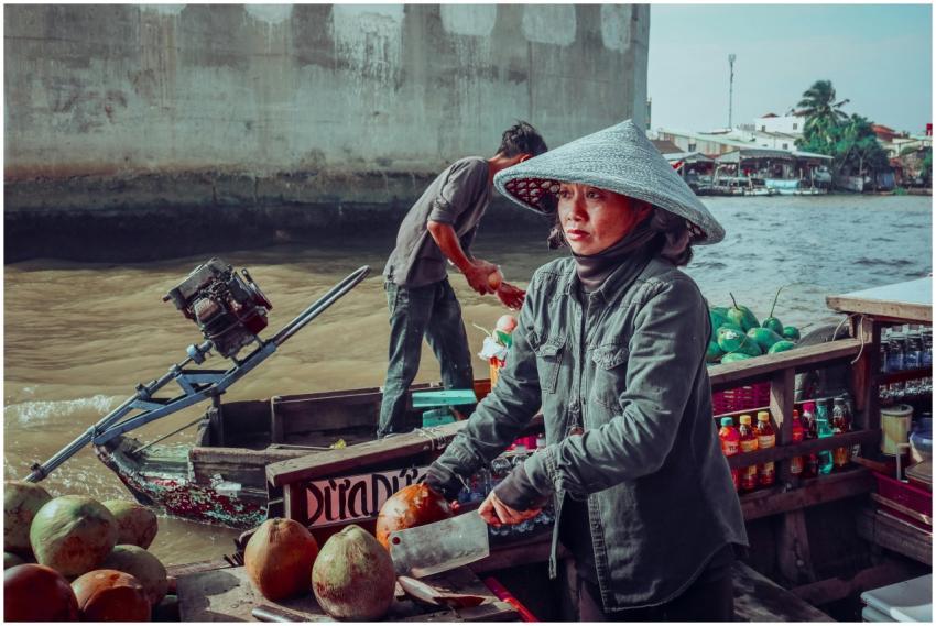 Vietnamese vendors selling coconuts on a floating