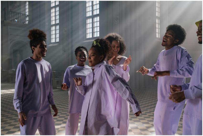 Group of diverse singers practicing joyfully insid