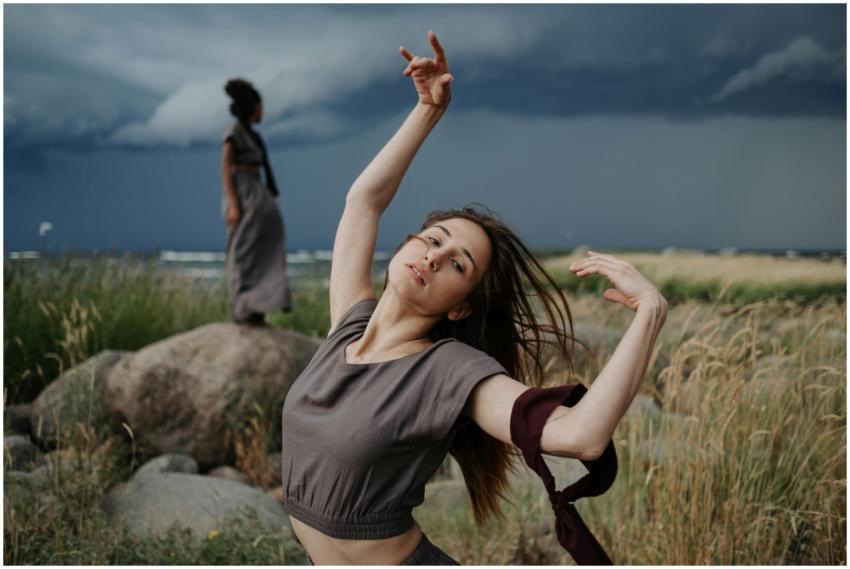 A woman dancing expressively in a natural outdoor