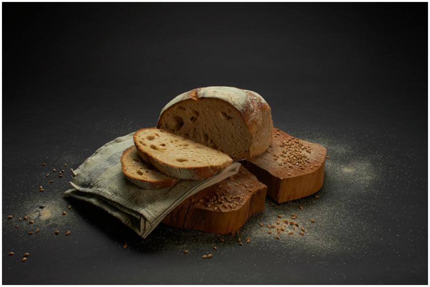 Sliced sourdough bread on a rustic surface, showca