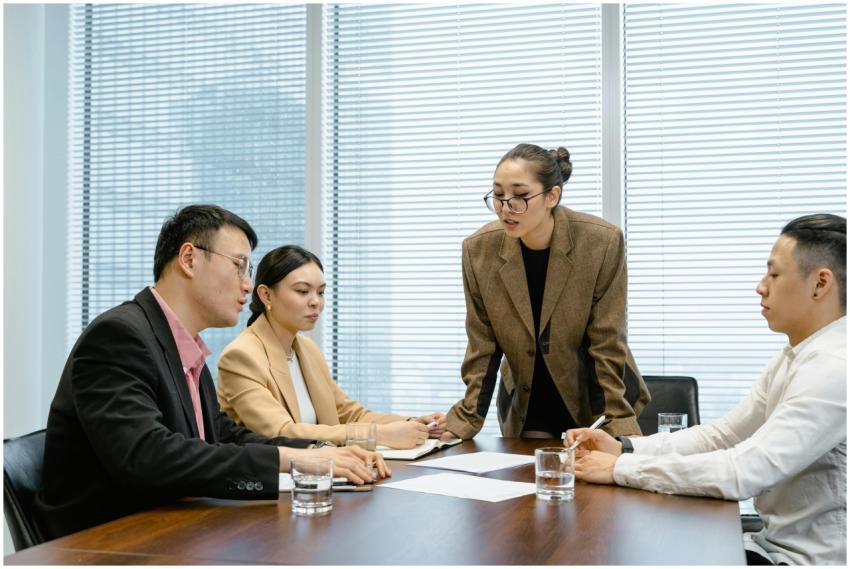 Business team engaged in a thoughtful meeting arou