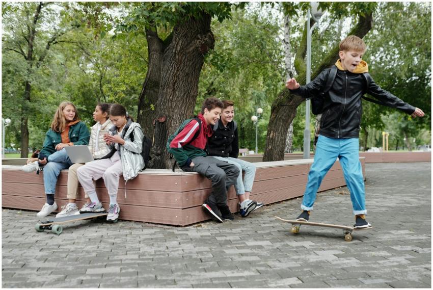 Group of teenagers having fun with skateboarding i