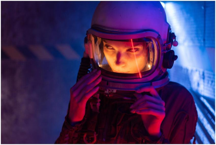 A woman in a futuristic space helmet with vibrant