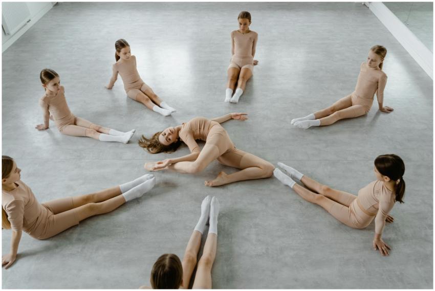 A group of young female dancers in a dance studio