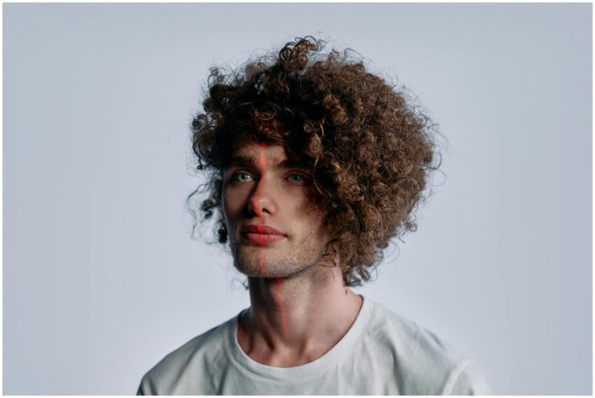 Portrait of a young man with curls and futuristic
