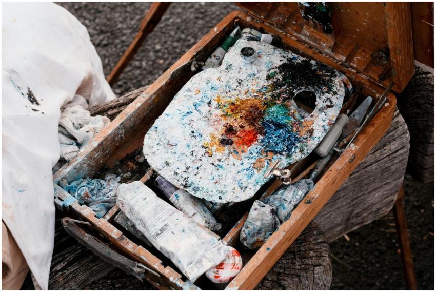 Colorful artist's paint palette and brushes in a w