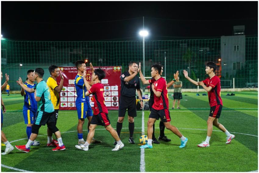 Players and referee exchanging handshakes after a