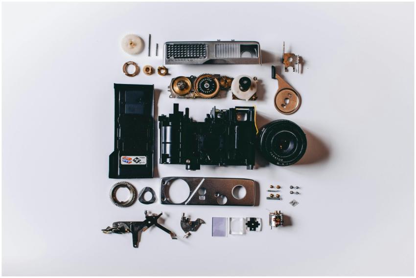 Flat lay of various disassembled camera parts on a