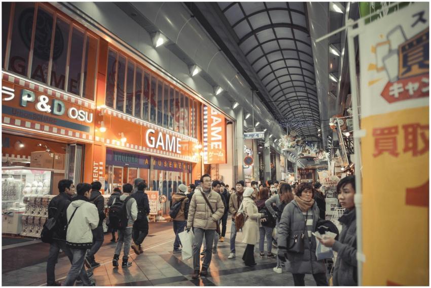 Crowded shopping arcade scene with people explorin