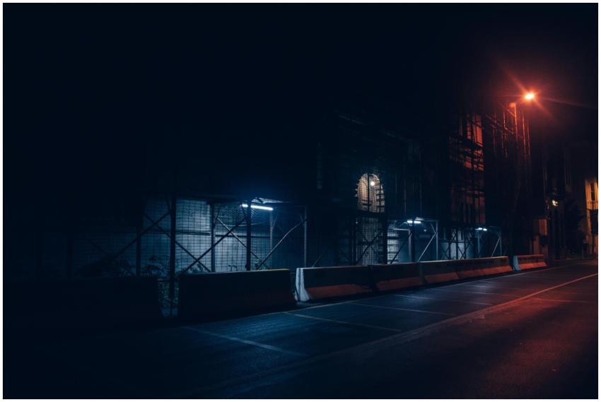A dark and moody urban street scene captured at ni