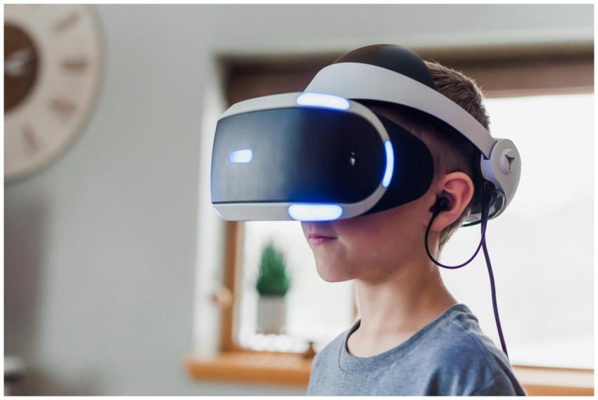 Young boy wearing a VR headset immersed in a virtu