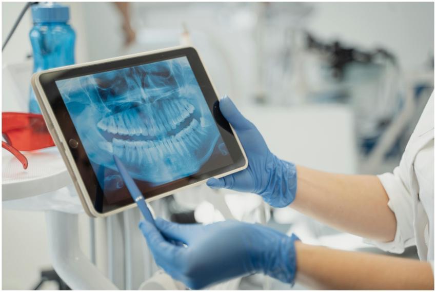 Close-up of a dentist analyzing a dental X-ray on