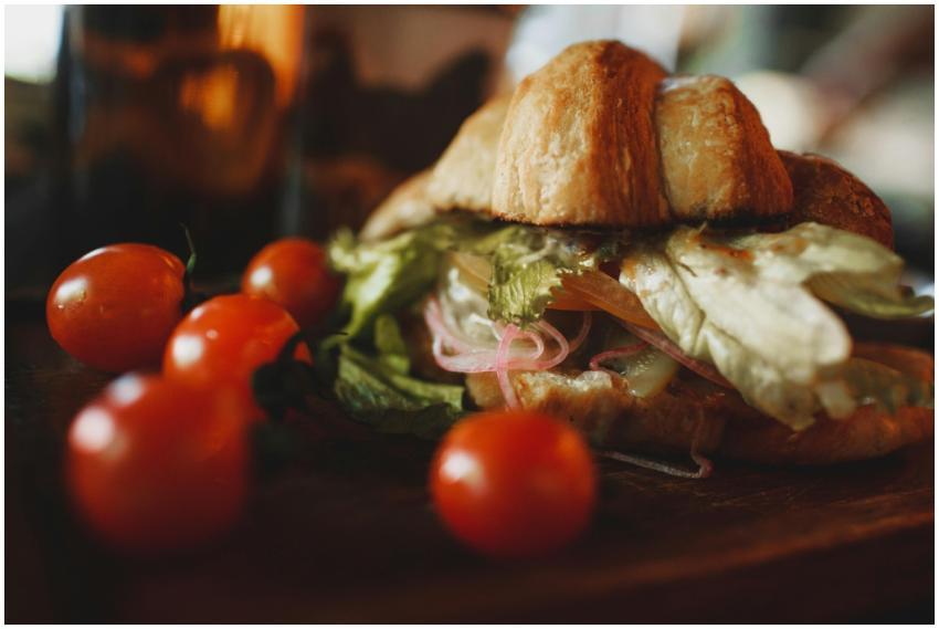 A delicious croissant sandwich served with fresh c