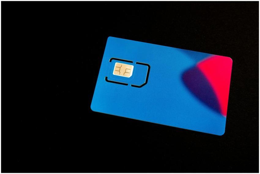 A blue SIM card on a dark background with vibrant