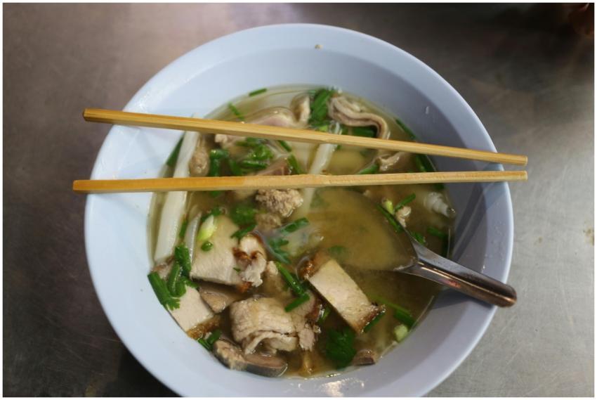 Authentic Asian noodle soup garnished with pork sl