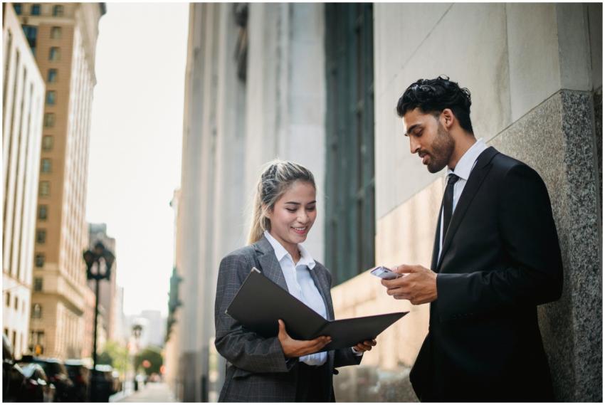 Two business professionals discussing a project ou