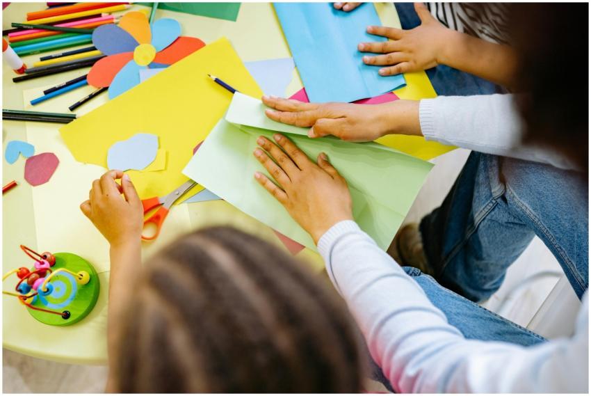 Kids crafting with colorful paper and materials in