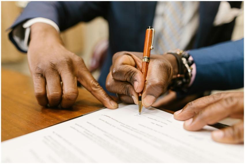 Close-up of business professionals signing a legal