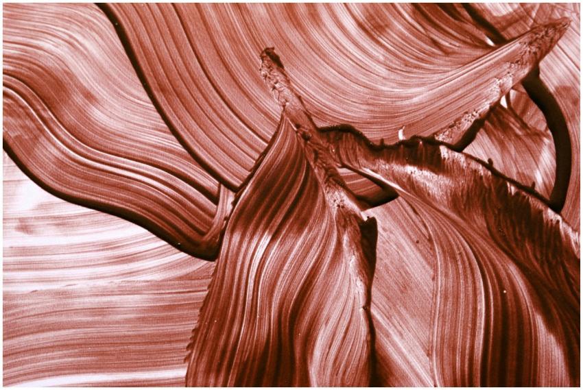 Abstract red brushstroke pattern creating a fluid