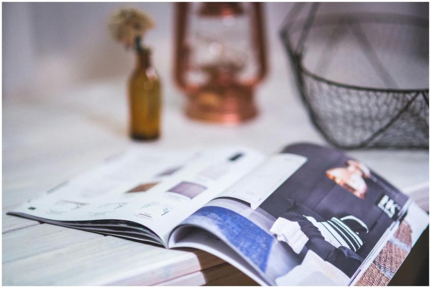 A stylish open magazine on a minimalistic desk wit