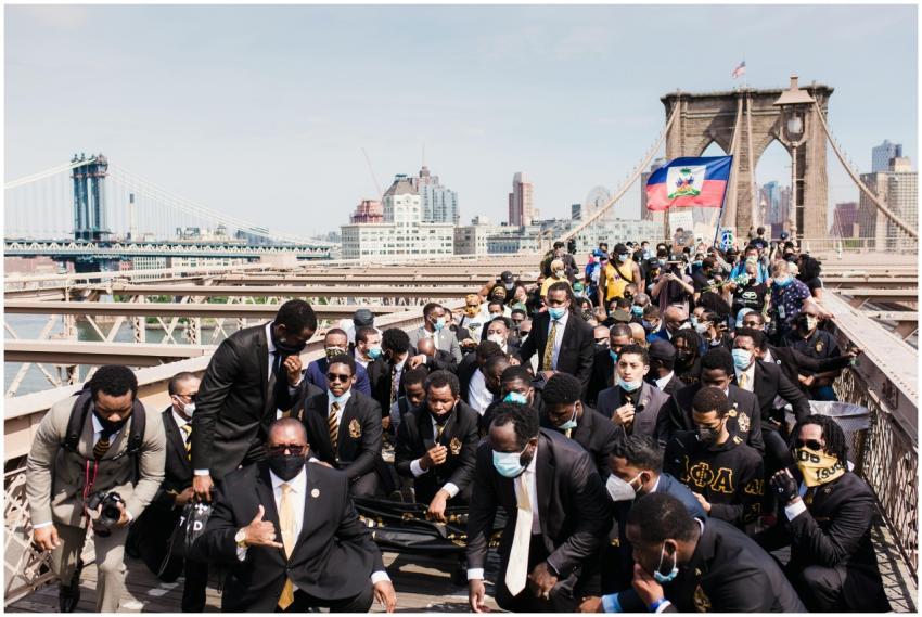 A large protest on Brooklyn Bridge featuring diver